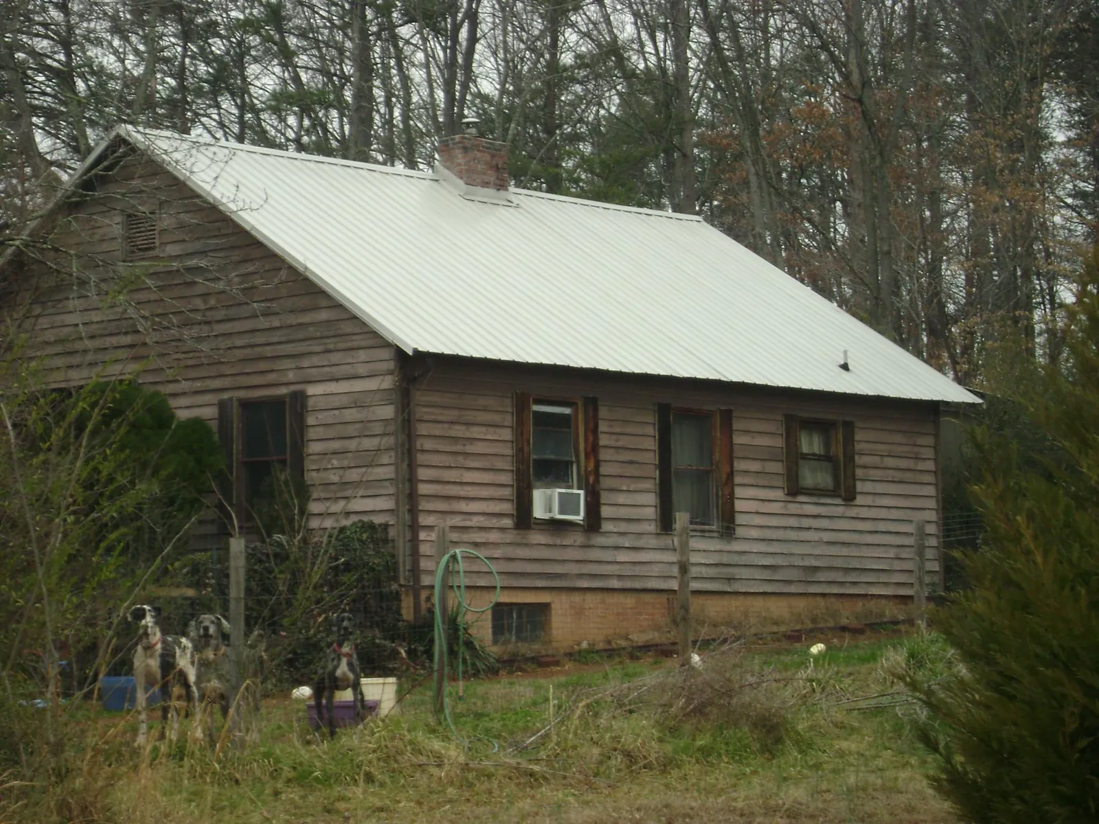 White metal roof on an old wood sided farmhouse, from a Metal Roof Installation job in Providence Forge